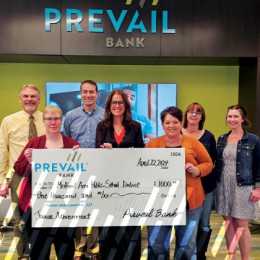 Staff presenting donation check to local organization