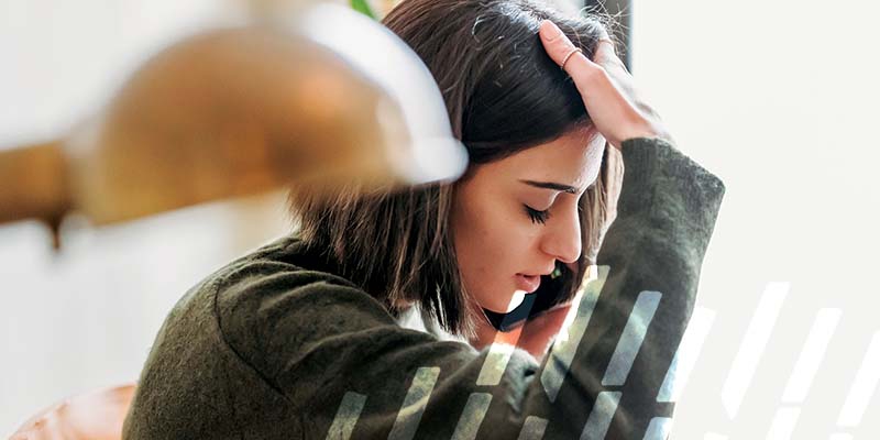 Upset woman talking on her phone.