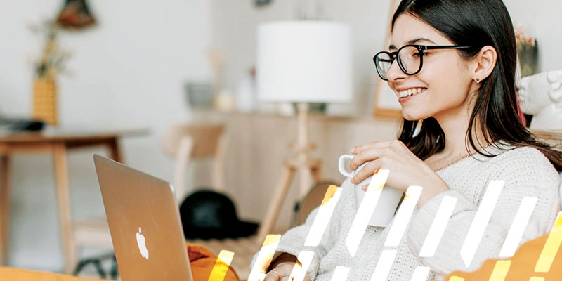 young adult on her laptop and drinking coffee