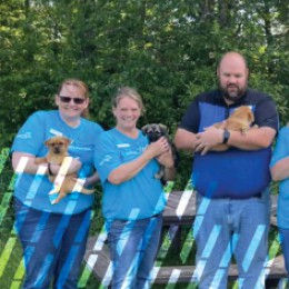 Prevail Bank Team Holding Puppies