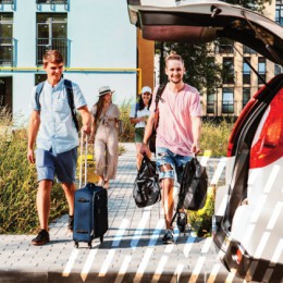 Young adults loading a car with luggage
