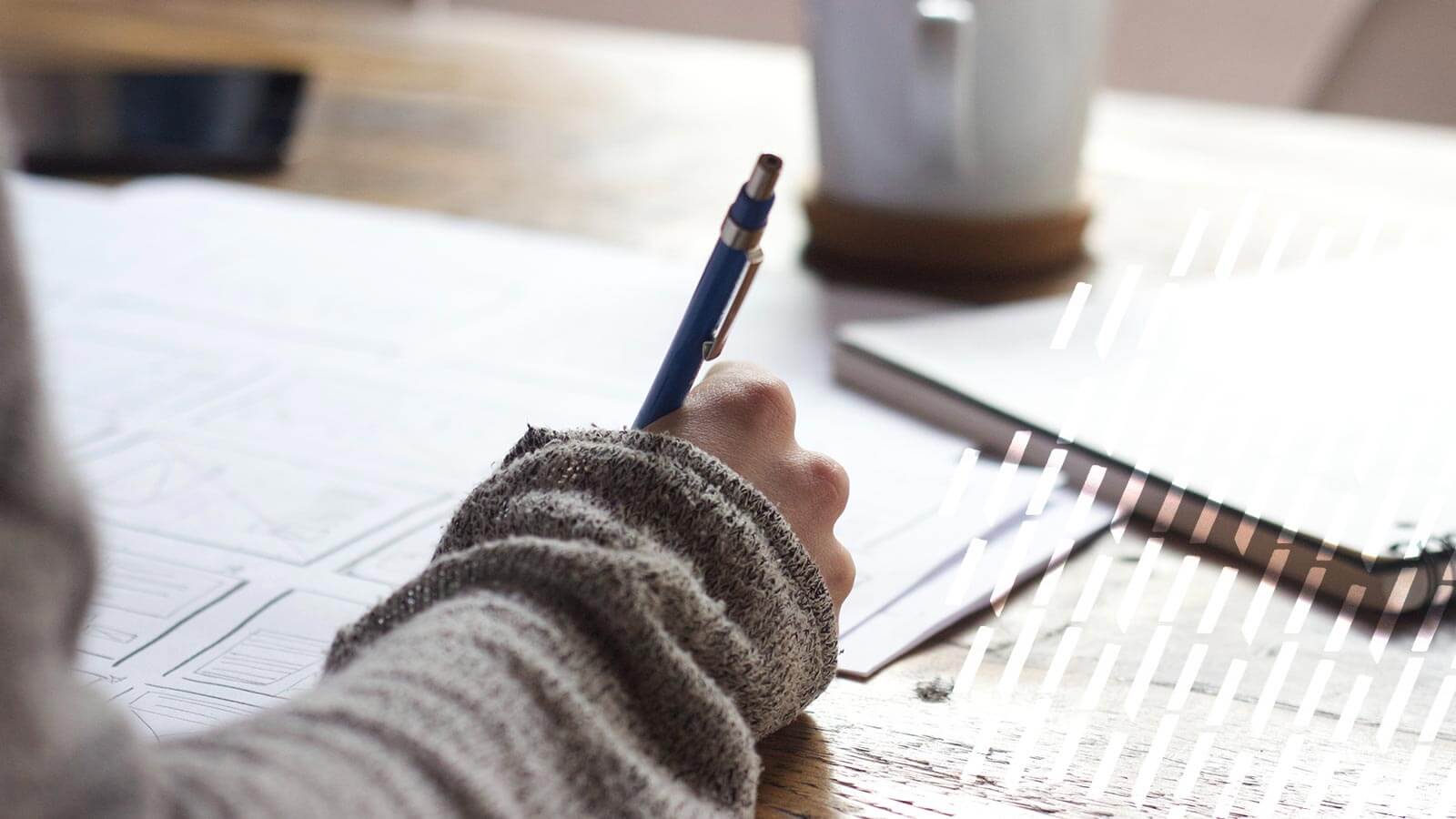 Person writing at a table.